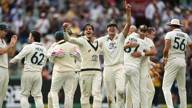 Sam Konstas and Pat Cummins celebrate victory against India at the MCG on Monday. Picture: Getty