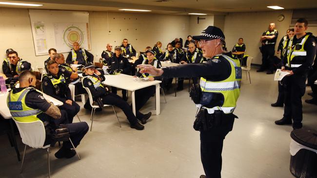 A senior sergeant addresses officers in the briefing room under the MCG. Picture: David Caird