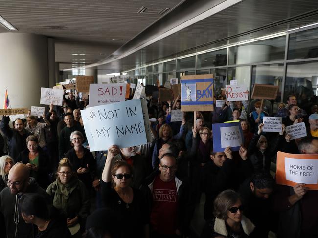 Demonstrators hold signs during a rally against a ban on Muslim immigration at San Francisco International Airport. Picture: Getty