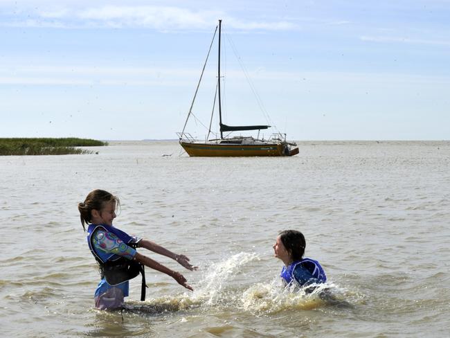 Fun in the water at Lake Alexandrina -  Annie Burgess (9) of Henley Beach with her sister Harriet (6) enjoying the water of Lake Alexandrina at Milang. The water was over 2 kilometres away from the shore line in 2009. The boat in the background was high and dry last year.