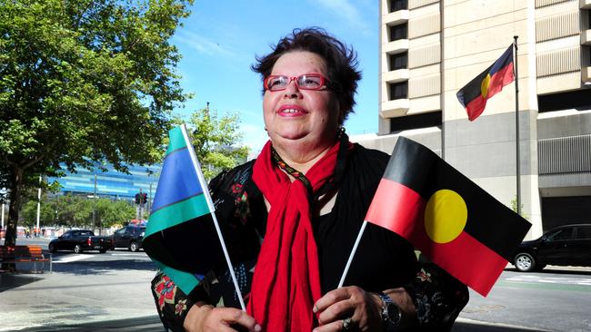 Kaurna elder Lynette Crocker with the Aboriginal flag and the Torres Strait Islands flag. Picture: Mark Brake