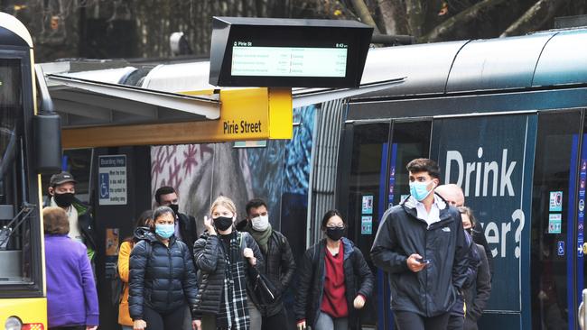 Doing the right thing: Public transport users wearing masks in the city. Picture: Michael Marschall