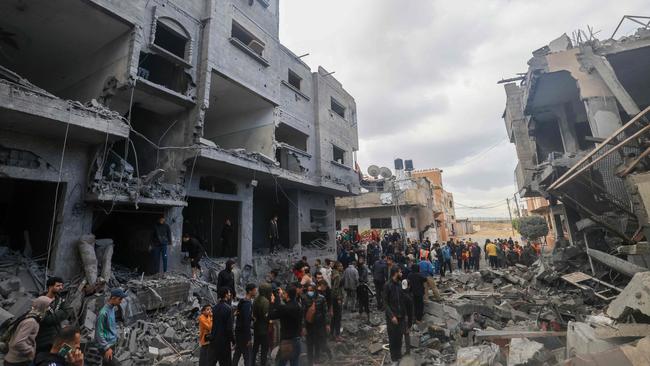 Palestinians walk amid the rubble of buildings damaged during an Israeli strike on Rafah in the southern Gaza Strip on November 20, amid continuing battles between Israel and the militant group Hamas. Picture: Mahmud Hams/AFP