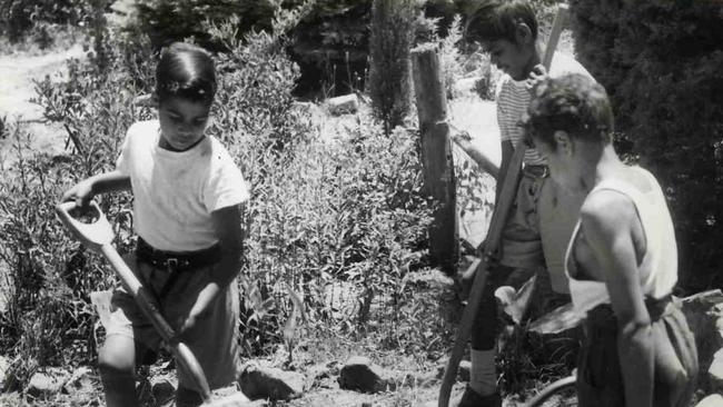 (L-r) Francis McHughes with Raymond Argent and Graham McKenzie working in the garden at Colebrook Home for Aboriginal Children, Jan 1957. Picture: Staff photographer