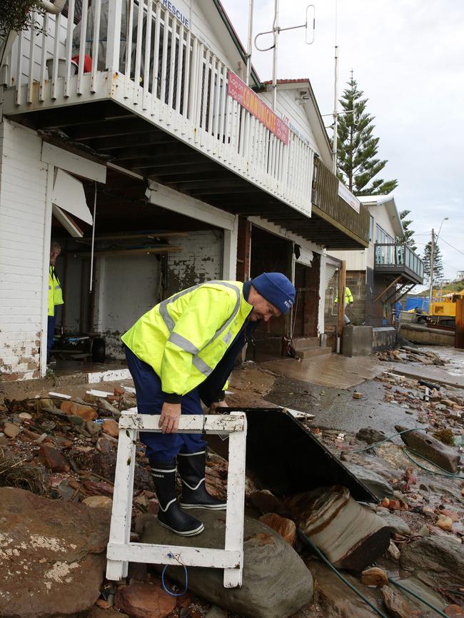 Marine Rescue Terrigal Controller Cameron Sloey leads the massive clean-up job at its headquarters this morning. Pictures Mark Scott