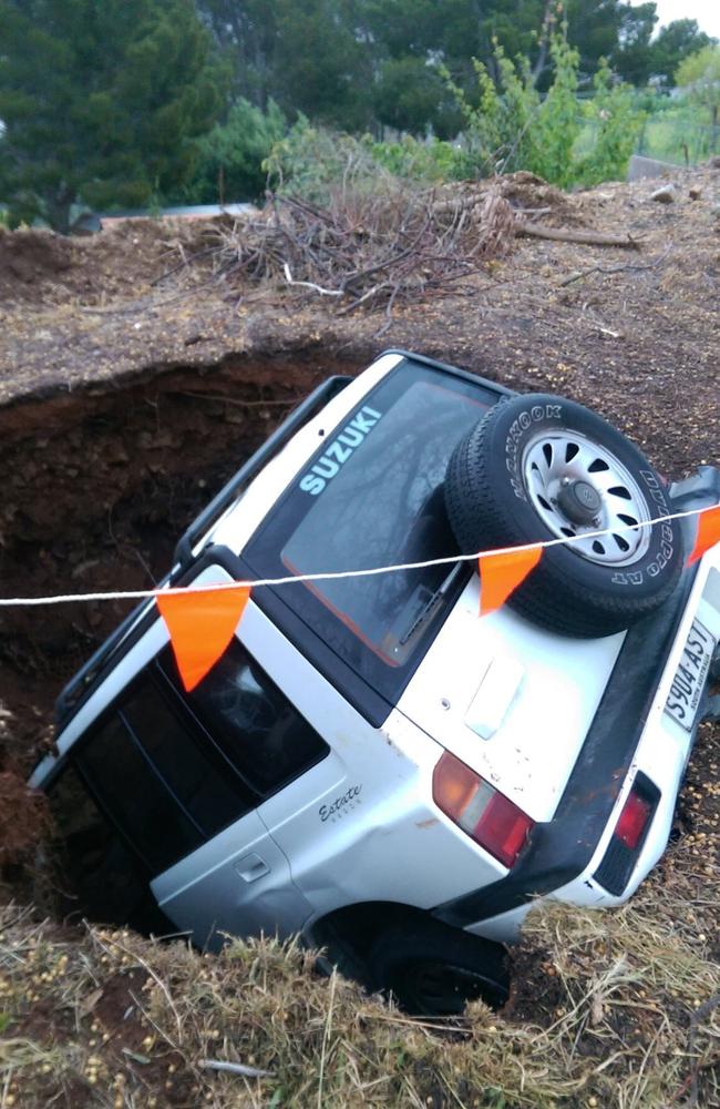 A sinkhole has swallowed a white Suzuki in Glen Osmond, South Australia. Picture: Jordanna Schriever