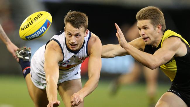 Adelaide's Tom Doedee clears by hand. Picture: Michael Klein