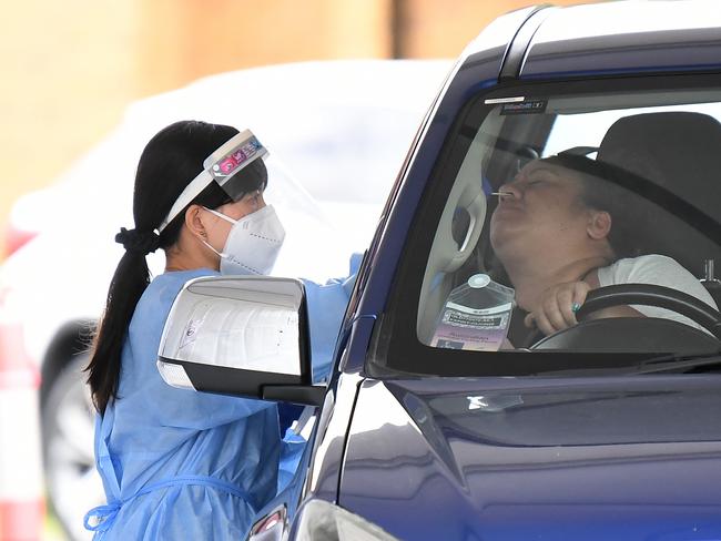 BRISBANE, AUSTRALIA - NewsWire Photos - NOVEMBER 4, 2021. A health worker swabs a member of the public at a pop up COVID-19 testing clinic in Brisbane.Picture: NCA NewsWire / Dan Peled