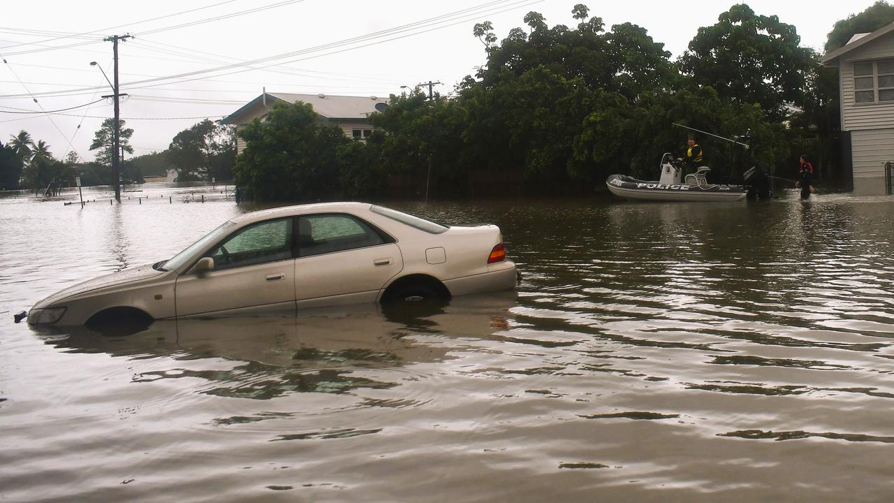 A Queensland Police Service rescue boat navigating floodwaters on the inundated intersection of Davidson and McIlwraith Street just off the Bruce Highway in Ingham, Hinchinbrook Shire. Picture: Cameron Bates