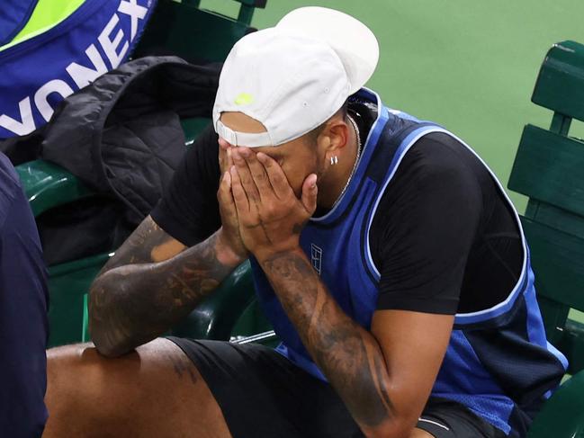 INDIAN WELLS, CALIFORNIA - MARCH 06: Nick Kyrgios of Australia shows his dejection as he is surrounded by medical personel after having to retire due to a wrist injury against Botic Van De Zandschulp of the Netherlands in their first round match during the BNP Paribas Open at Indian Wells Tennis Garden on March 06, 2025 in Indian Wells, California.   Clive Brunskill/Getty Images/AFP (Photo by CLIVE BRUNSKILL / GETTY IMAGES NORTH AMERICA / Getty Images via AFP)