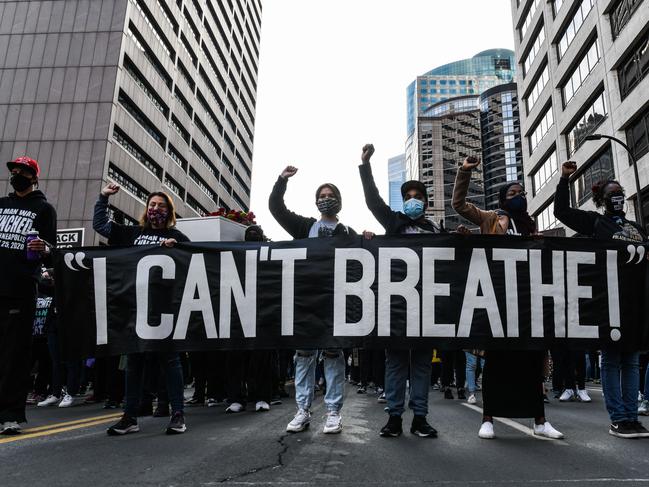 Demonstrators hold a banner during the Silent March for Justice in front of the court where the trial of former Minneapolis police officer Derek Chauvin will occur. Picture: AFP