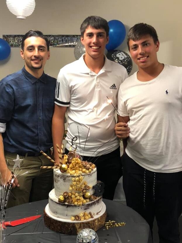 Christopher celebrates his 18th birthday with brothers Michael (right) and Adriano.