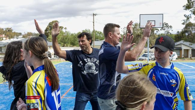 Laurie Daley and Steve Menzies pass the footy with Junee High School students. Picture: Sean Davey