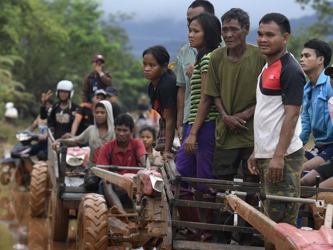 Flood victims wait for food aid in Sanamxai, Attapeu province. Picture: AFP