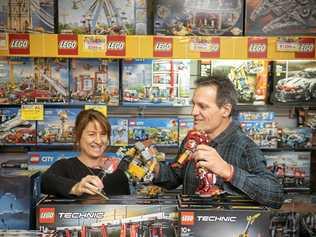 Toyworld Maclean owners Sharon and Boyd Moore play with one of their favourites, the vast Lego collection. Picture: Adam Hourigan