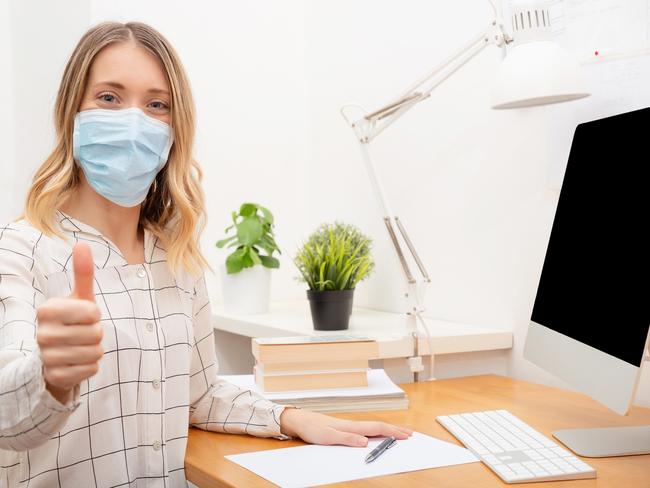 f40stream. Important to take steps to improve wellbeing in the time of social isolation and working from home. Covid-19.Young business woman working from home wearing protective mask