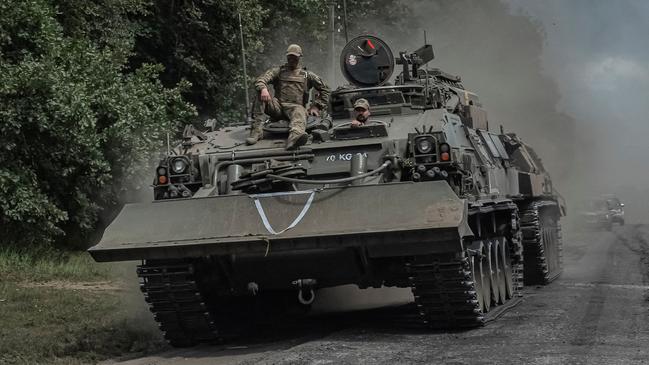 Ukrainian servicemen ride a military vehicle, amid Russia's attack on Ukraine, near the Russian border in Sumy region, Ukraine, on Saturday. Picture: Reuters/Viacheslav Ratynskyi