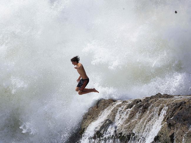 Gold Coast beaches including Snapper Rocks are getting battered as huge seas from Cyclone Seth bash the coastline. Some daredevil types couldn't resist jumping from rocks as waves exploded behind them Pics Adam Head