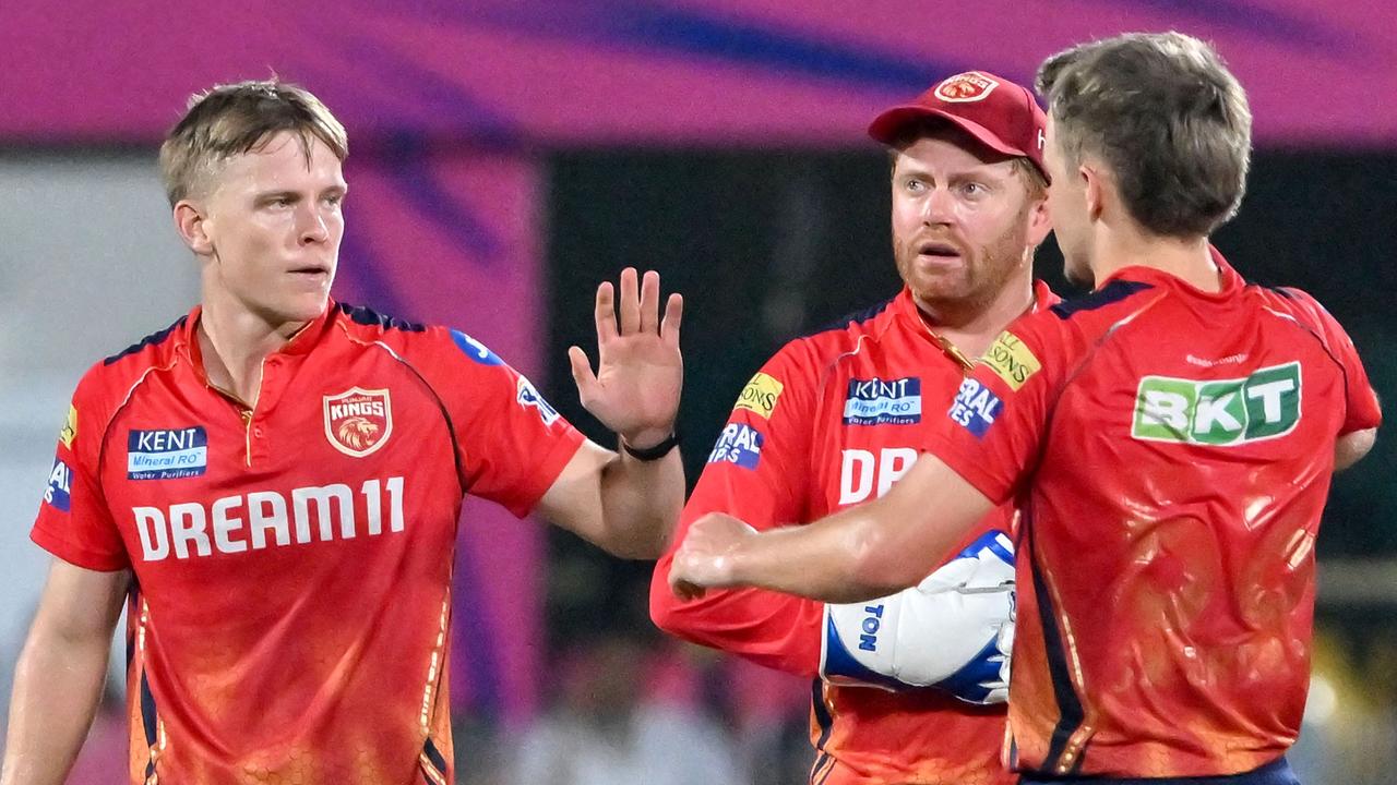 Punjab Kings' Nathan Ellis (L) celebrates with England teammates Sam Curran (R) and Jonny Bairstow on May 15, 2024. (Photo by Biju BORO / AFP)