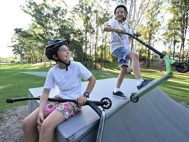 30/03/2023: L-R brothers Jack 13 and Ollie 11 Breen, with their scooters in an park in Ashgrove, Brisbane.  pic Lyndon Mechielsen/Courier Mail