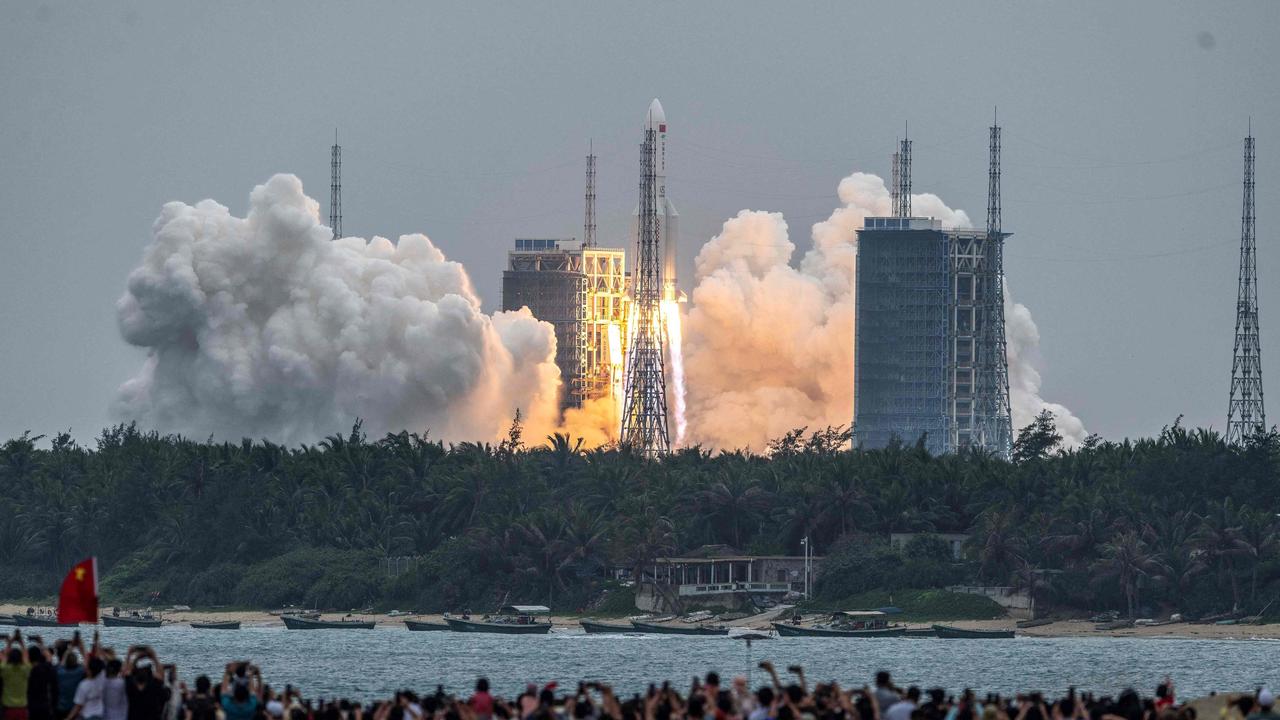 People watch a Long March 5B rocket, carrying China's Tianhe space station core module, as it lifts off from the Wenchang Space Launch Centre in southern China’s Hainan province on April 29, 2021. Picture: AFP