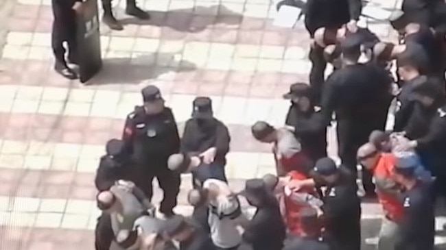 A screengrab showing blindfolded and shackled Uighurs in China’s Xinjiang Province. Picture: YouTube