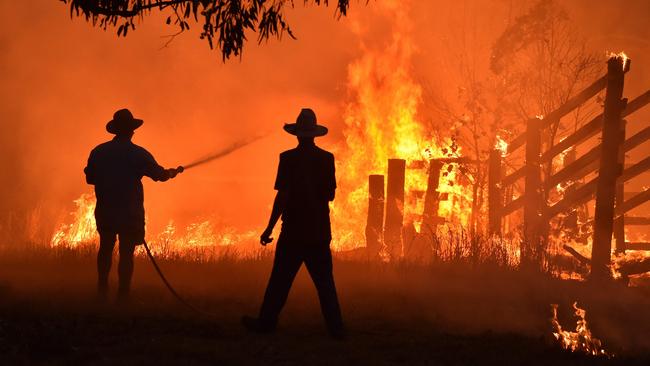 Residents defending a property from a bushfire at Hillsville near Taree, 350km north of Sydney, last year. Picture: AFP