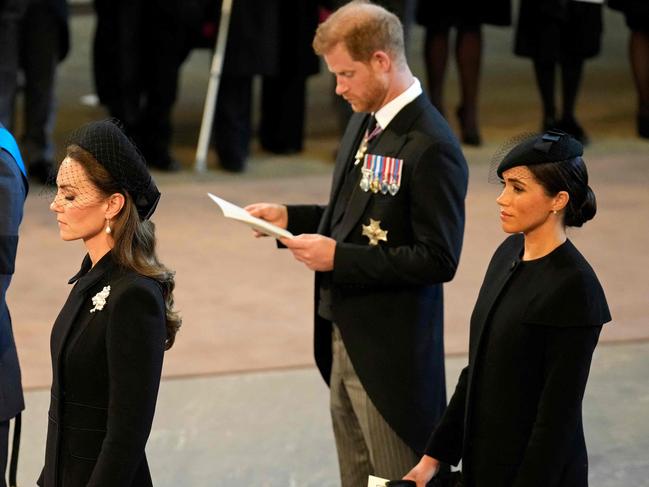 CORRECTION / TOPSHOT - Britain's Prince William (L), Prince of Wales, Britain's Catherine (2nd L), Duchess of Kent, Britain's Prince Harry (2nd R), Duke of Sussex, and Meghan (R), Duchess of Sussex, stand after participating in the procession of the coffin of Queen Elizabeth II, to Westminster Hall, at the Palace of Westminster, in London on September 14, 2022, where she will Lie in State on a Catafalque. - Queen Elizabeth II will lie in state in Westminster Hall inside the Palace of Westminster, from Wednesday until a few hours before her funeral on Monday, with huge queues expected to file past her coffin to pay their respects. (Photo by Christopher Furlong / POOL / AFP) / âThe erroneous mention[s] appearing in the metadata of this photo by Christopher Furlong has been modified in AFP systems in the following manner:[Britain's Catherine] instead of [Britain's Katharine]. Please immediately remove the erroneous mention[s] from all your online services and delete it (them) from your servers. If you have been authorized by AFP to distribute it (them) to third parties, please ensure that the same actions are carried out by them. Failure to promptly comply with these instructions will entail liability on your part for any continued or post notification usage. Therefore we thank you very much for all your attention and prompt action. We are sorry for the inconvenience this notification may cause and remain at your disposal for any further information you may require.â