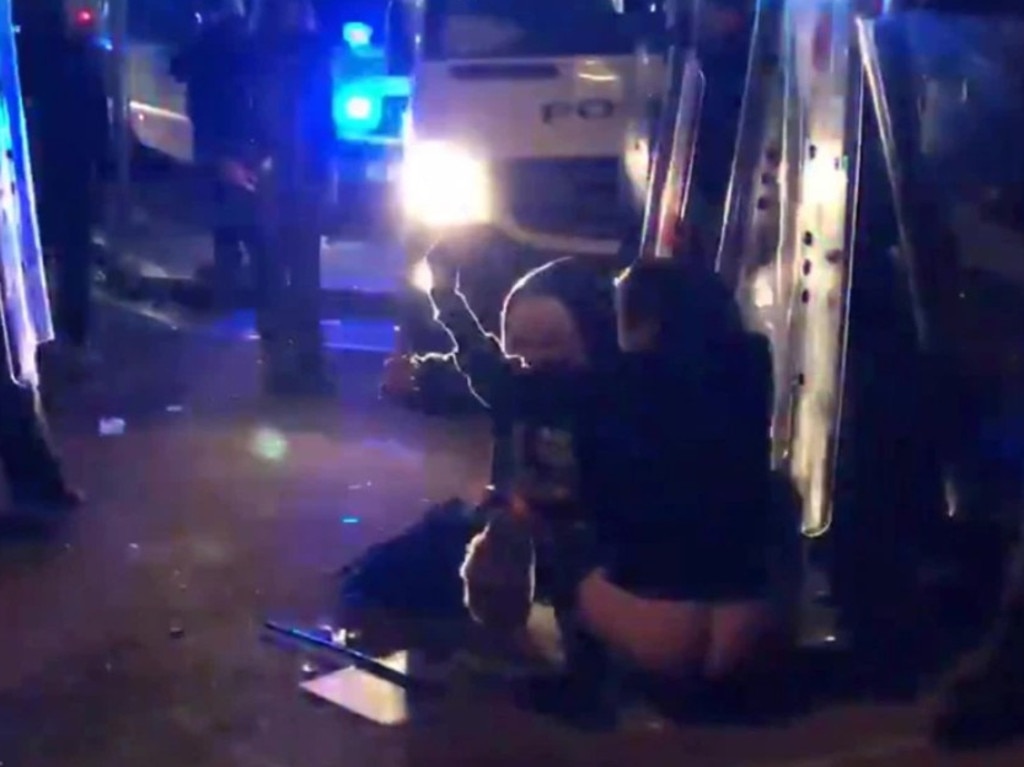 Female rioters are seen urinating and defecating at the feet of British police officers during the Kill the Bill protest in Bristol. Picture: SWNS/Mega