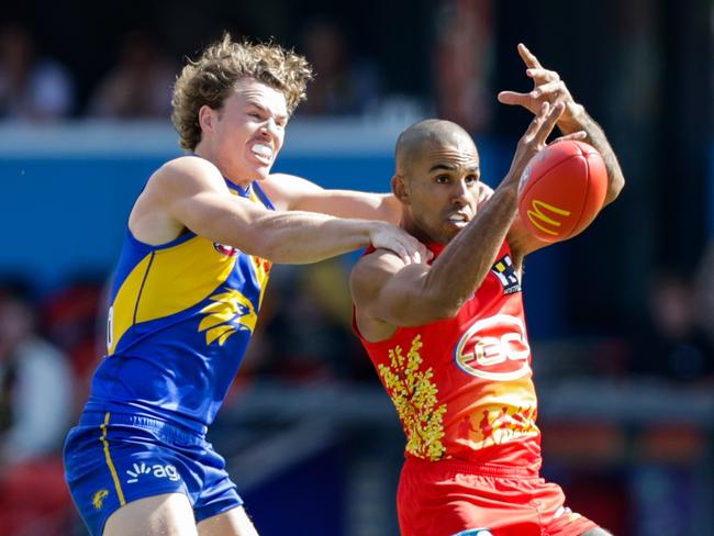 Touk Miller under pressure from Jayden Hunt. Picture: Russell Freeman/AFL Photos via Getty Images