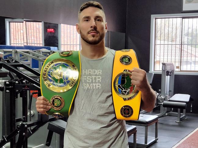 Kris Terzievski shows off his belts at Mace Fitness. Picture: Ben Higgins