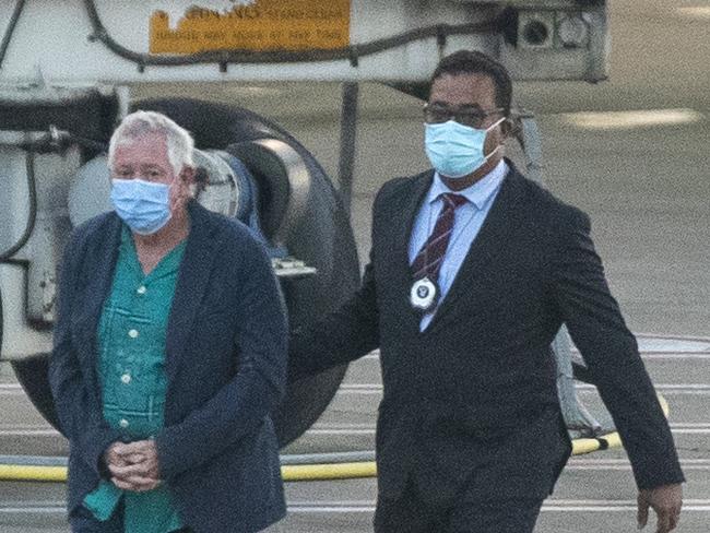 James Blake Blee is escorted under heavy police guard at Sydney airport after being extradited from Cairns. He has been charged with importation of a large commercial quantity of a border controlled drug. Picture: Liam Mendes / The Australian