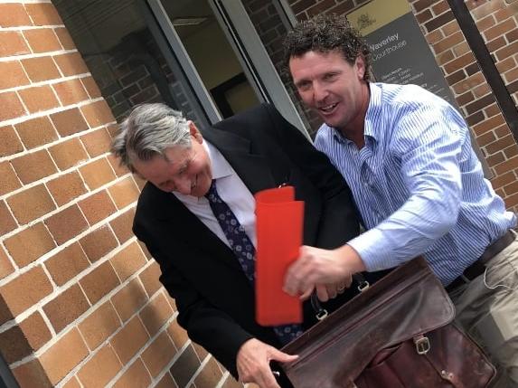 Denis Thomey (right) was all smiles outside court.