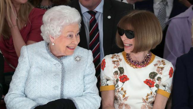 Queen Elizabeth II, accompanied by Anna Wintour, views British designer Richard Quinn’s runway show.