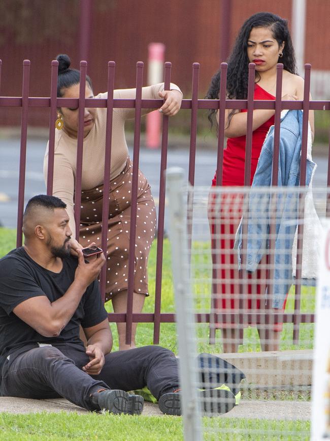 Two women comfort an injured man. Picture: Jay Town