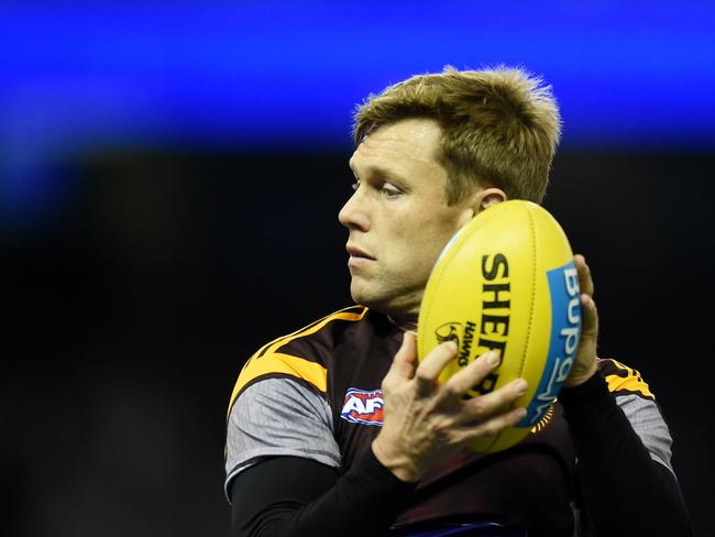 **FILE** A Friday, June 17, 2016 image reissued Wednesday, Oct. 12, 2016 of Sam Mitchell of the Hawks warms up before the North Melbourne Kangaroos and Hawthorn Hawks round 13 match at Etihad Stadium in Melbourne. Hawthorn champion Sam Mitchell has delivered the biggest bombshell of AFL trade week, expressing interest in joining West Coast on a one-year playing contract, with a view to him securing a coaching gig with the Perth-based club after his playing career. (AAP Image/Tracey Nearmy) NO ARCHIVING