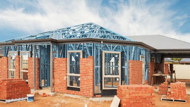 New residential construction home from brick with metal framing against a blue sky; real estate Australian generic suburban homes