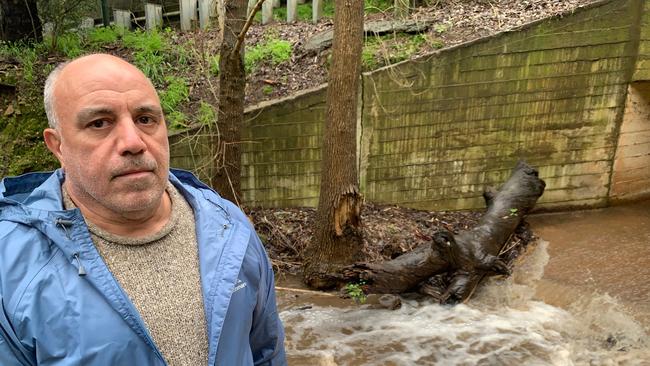 Residents Shayne and Elaine Varacalli at the site where Third Creek receives murky runoff from the Hanson White Rock Quarry at Horsnell Gully. The photo was taken close to the corner of Old Norton Summit Rd and Horsnell Gully Rd. Picture: Supplied.