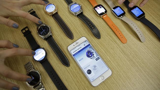 In this Aug. 21, 2015, a number of new Android Wear smartwatches compatible with the Apple iPhone are posed for a photo at Google's offices in San Francisco. Google is introducing an application that will connect Android smartwatches with Apple's iPhone, escalating the rivals' battle to strap their technology on people's wrists. (AP Photo/Eric Risberg)