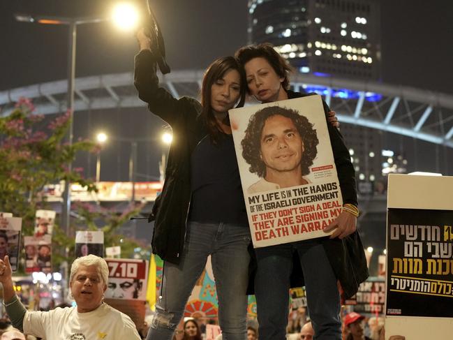 Relatives and friends of people killed and abducted by Hamas and taken into Gaza, react to the ceasefire announcement as they take part in a demonstration in Tel Aviv, Israel, Wednesday, Jan. 15, 2025. (AP Photo/Ohad Zwigenberg)