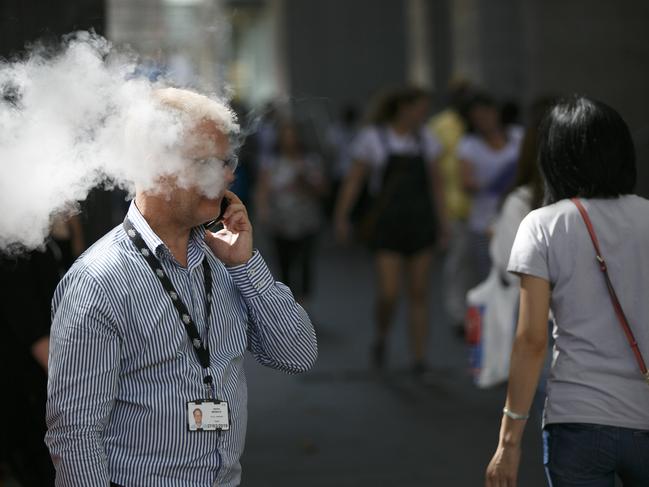 Numbers of smokers line the street causing a smoke hazard for locals and pedestrians.Pedestrians on Pitt St trying to get past the wave of constant smoke.Photo: Tim Pascoe