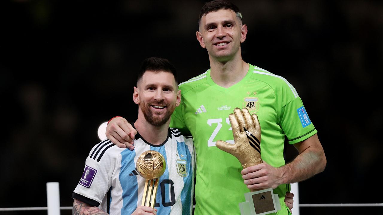 Adidas Golden Ball winner Lionel Messi (L) and adidas Golden Glove winner Emiliano Martinez (R).