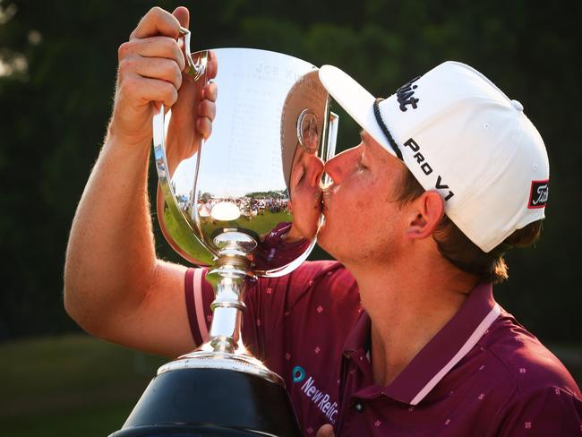 Cameron Smith of Australia celebrates with the Kirkwood Cup after winning the Australian PGA Championship at the Royal Pines golf course on the Gold Coast. (Photo by Patrick HAMILTON / AFP) /