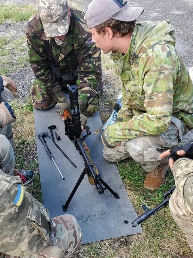 Felix Metrikas, right with an Ukrainian soldier assembling a PKM machine gun in Hostomel in the country's north.