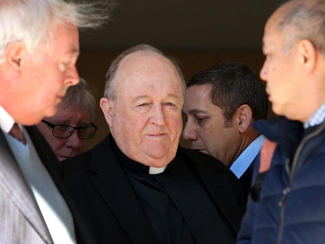 Former Australian archbishop Philip Wilson (C) leaves a court in Newcastle on August 14, 2018. - Wilson, a former Australian archbishop convicted of concealing abuse by a notorious paedophile priest in the 1970s, was spared jail on August 14, with a court ruling he can serve his sentence in home detention. (Photo by Peter LORIMER / AFP)