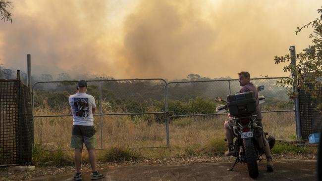 Locals look on as the fire rages in the distance: Picture: NewsWire / Jeremy Piper