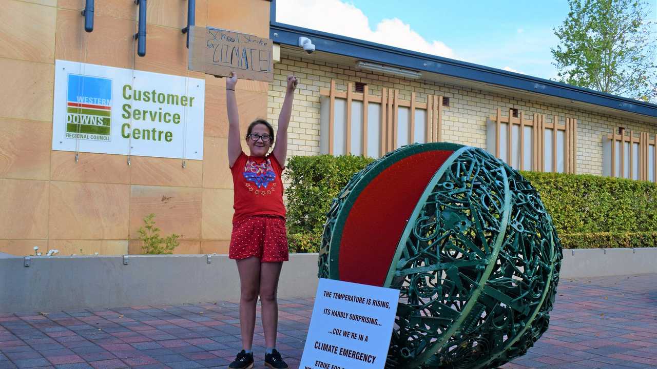 TAKING A STAND: Instead of enjoying her last day of the terms at her school&#39;s "Celebration Day", 12-year-old Ariel Ehlers from Chinchilla is taking a stand against climate change and protesting for climate action outside the Western Downs. Picture: Kate McCormack