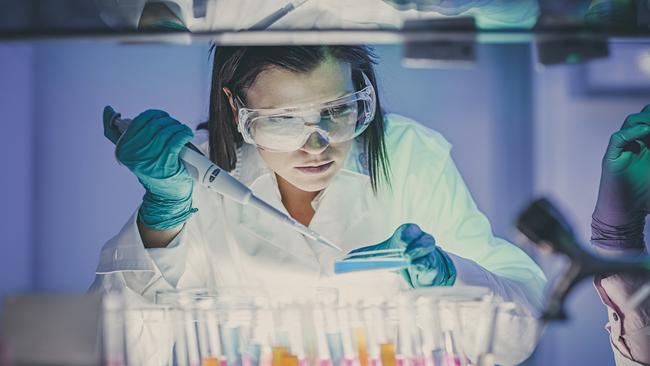 scientist, doctor, asistent working at the laboratory using pipette