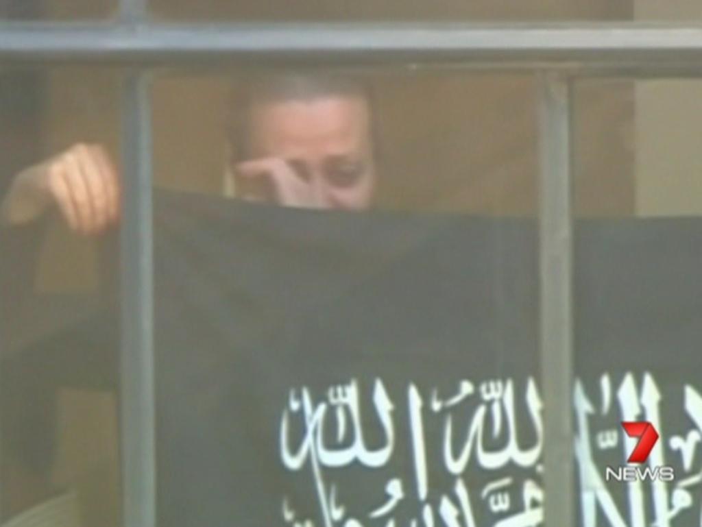 1. It is the moment that changed us forever. Sydney watches in horror as a distressed hostage holds up a black IS-related flag at the window of the Lindt Cafe in Martin Place, signalling the start of a 17-hour siege.