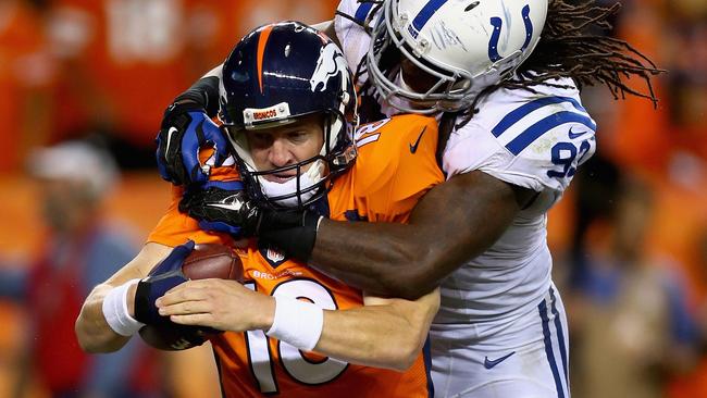 Peyton Manning is crunched by Colts player Erik Walden.